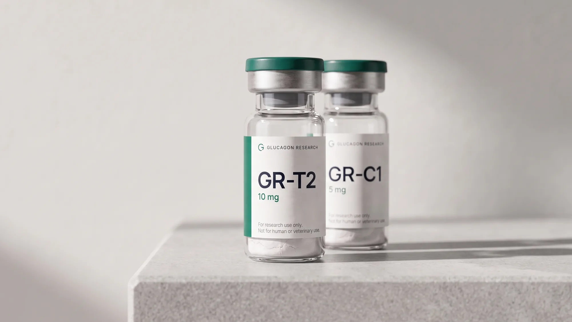 Two sealed Glucagon Research vials standing on a pale stone plinth